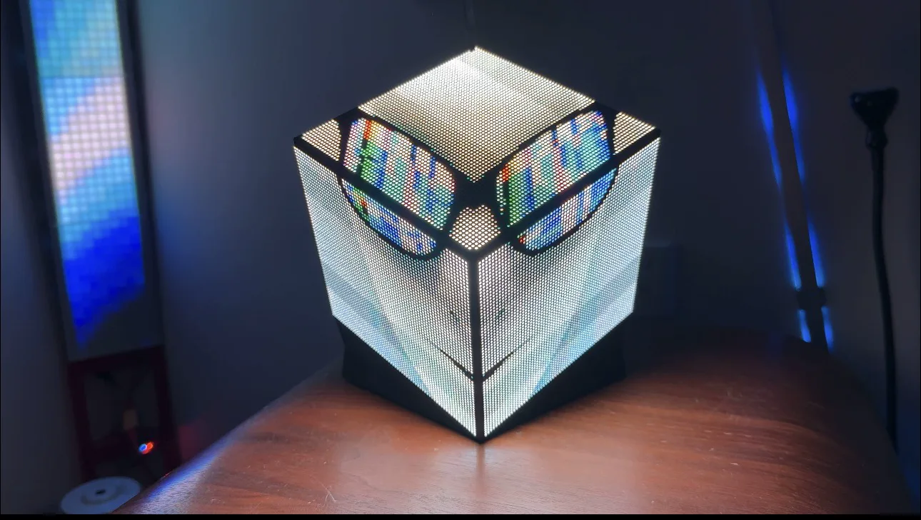Prism-64 displaying a pixel-art face wearing glasses